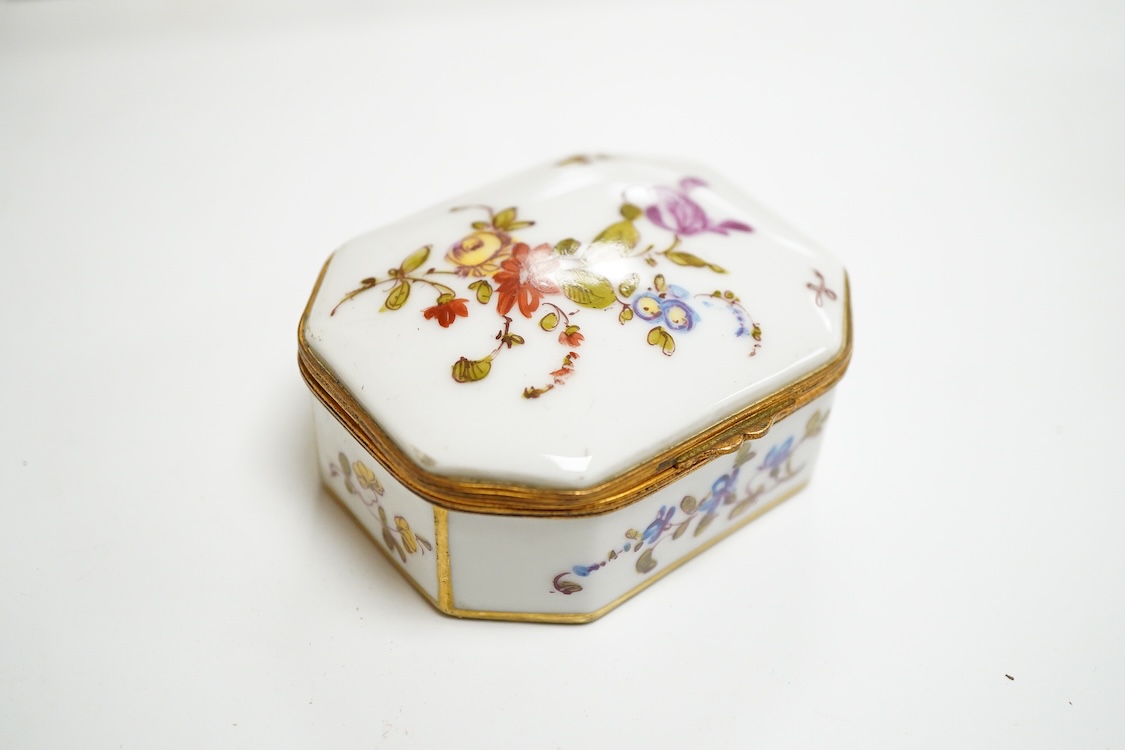 Three early 20th century French porcelain snuff boxes with floral decoration, 7cm wide
